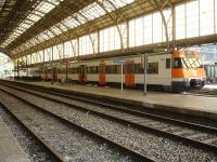 A 3 coach Renfe Rodalies de Catalunya liveried EMU stands under the impressive overall roof at Portbou on the afternoon on 7 August 2015, awaiting departure on the next service towards Barcelona Sants.<br><br>[David Pesterfield 07/08/2015]