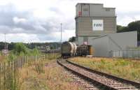 Freightliner Heavy Haul services from Oxwellmains to Aberdeen and Inverness now convey – thanks to award of Freight Facilities Grant – bogie vans of bagged cement which formerly moved by road. Both hopper wagons and vans can be seen in this shot of the Lafarge cement terminal deep in Millburn Yard, Inverness on 28th August 2015.<br><br>[David Spaven 28/08/2015]