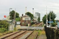 Tutbury and Hatton station, looking towards Derby on 30 August. The original station closed in 1966 but reopened in 1989 with platforms staggered either side of the level crossing. The large factory in the background is owned by Nestle and was rail served until the 1970s. <br><br>[Mark Bartlett 30/08/2015]