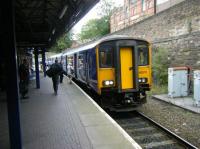 Northern Sprinter 150275 calls at Wigan Wallgate on a service heading for Manchester. There was originally an additional line through the cutting here but it was lifted a long time ago. <br><br>[Veronica Clibbery 17/09/2015]