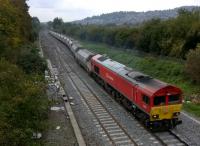 Having waited patiently for an up HST to pass, DBS liveried 59.201 snakes out of the loop to turn right towards the coast. The load was ballast; I believe this was a 13.20 Westerleigh to Westbury working. The ramshackle hut [see image 42584] has been flattened as part of the renewal of the junction.<br><br>[Ken Strachan 10/10/2015]