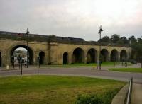 An HST service for Bristol accelerates out of Chippenham station [see image 49442] over the Western Arches. The arches were built in 1841 and widened in 1848; there is a pub named after the designer (IKB, no less) just beyond the big arch on the left.<br><br>[Ken Strachan 10/10/2015]