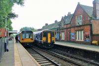 The fine looking station building at Romiley is still fully staffed and the station enjoys regular services to Manchester Piccadilly via both Hyde and Reddish. Here a Pacer heading for the Rose Hill branch meets a Sprinter going into the city on 1st September 2015.<br><br>[Mark Bartlett 01/09/2015]