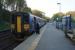 A Falmouth Docks to Truro service waits at the northern end of Penryn station on 12 October 2015 to pass the southbound service. The passing loop is on the left but the southbound service stops behind the photographer at the same platform. <br><br>[John McIntyre 12/10/2015]