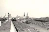 Workers platforms at Singer, looking west in April 1958. At its peak the huge factory employed over 16,000 workers. Final closure came in June 1980 and the last of the building complex was demolished in 1998. Much of the site is now occupied by the Clydebank Shopping Centre [see image 7266]. <br><br>[G H Robin collection by courtesy of the Mitchell Library, Glasgow 12/04/1958]