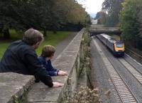 Sydney Gardens, Bath has long been a classic location to watch and photograph trains. This is the High Level viewing gallery [see image 52886]. A father and son enjoy the spectacle as an up HST powers away from Bath Spa through the gardens.<br><br>[Ken Strachan 10/10/2015]