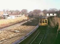 A <I>Calder Valley</I> BRCW Class 110 DMU passes through the closed station of St Lukes on a service from Manchester to Southport in 1980. This was known as the Preston platform and had closed in 1968. Another on the direct Wigan line had closed in 1965. The station has since been completely cleared away but the tracks still widen at this point to pass under the road bridge.  <br><br>[Mark Bartlett //1980]