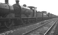 A lineup of stored locomotives awaiting disposal alongside Bo'ness Harbour in February 1962 following a shower of rain. Directly ahead stands J35 0-6-0 no 64472, not officially withdrawn from Kipps shed until the following month. The locomotive was eventually cut up at Connel's of Coatbridge in November of that year.<br><br>[K A Gray 26/02/1962]