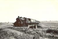 A train from St Combs photographed approximately 2 miles south of Fraserburgh on 5 August 1953. Ivatt 2-6-0 46460 is crossing the bridge over the Water of Philorth shortly after restarting from Philorth Bridge Halt. [See image 48605]<br><br>[G. H. Robin collection by courtesy of the Mitchell Library, Glasgow. 05/08/1953]