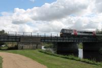 Seen from the grounds of the National Memorial Arboretum, a Cross Country Class 170 DMU crosses the River Tame heading north towards Burton-upon-Trent. <br><br>[Mark Bartlett 28/08/2015]