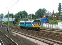 A Newcastle - Sunderland service passing Pelaw in July 2004, seen from the Metro station platforms. The former station master's house (since demolished following a fire) stands in the background. [Ref query 50469] <br><br>[John Furnevel 10/07/2004]