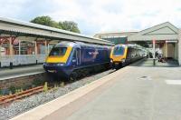 FGW HST power car 43152 and Cross Country Voyager 220026 stand in the main line platforms at Paignton awaiting departure time. Queen's Park station, for the Kingswear steam trains, is beyond the white picket fence. <br><br>[Mark Bartlett 28/07/2015]
