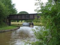 Around half way between Middlewich and Northwich on the little used route linking the latter with Sandbach, the line crosses the Trent & Mersey Canal immediately beyond Whatcroft Lane overbridge. The long steel bridge over the canal is seen here in July 2015. [Ref query 4343]<br><br>[David Pesterfield 16/07/2015]