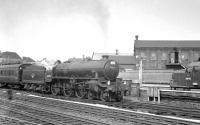 The south end of Doncaster on 31 May 1963, with Immingham B1 61056 at the head of a Cleethorpes – Sheffield Victoria relief service. In the background is EE Type 3 D6744, delivered new to Darnall shed just over a year earlier. 61056 was withdrawn from 40B the following May and cut up at the Central Wagon Works, Wigan, shortly thereafter. D6744 subsequently became 'Loadhaul' 37710 and was eventually obtained as a 'spares donor' by WCRC Carnforth in 2007 [see image 31684].<br><br>[K A Gray 31/05/1963]