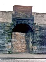 Riccarton & Craigie station entrance, close up showing decorative carving on the archway, 20 October, 1985, before the demolition men set to. There was still a short section of the island platform above at the time, located behind the red sandstone section of the wall above the arch, although the top of the stairs up from street level were buried.<br><br>[Robert Blane 20/10/1985]