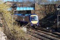 170403 on a service from Dunblane to Glasgow Queen Street passes overbridge 123, a structure which is shortly (March 2016) to be removed as part of the EGIP works.<br><br>[Colin McDonald 07/03/2016]