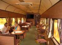 There is no shame in admitting that you can't quite stretch to £1000 for a single ticket from Cape Town to Johannesburg or vice versa in the Blue Train. But if you don't need a double bed to sleep on, and a private bathroom with bath, a similar level of luxury can be obtained in Premiere Class. The Lounge Car (no jeans allowed) is seen shortly after leaving Cape Town on 4th November 2005.<br><br>[Ken Strachan 04/11/2005]