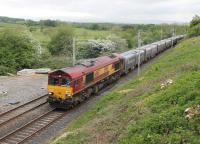 Recent clearing of vegetation has opened up a vantage point on Tarn Lane at Cinderbarrow where DB 66167 is seen heading south with the evening Hardendale to Margam containers on 23rd May 2016. The train has just crossed the Cumbria and Lancashire border. <br><br>[Mark Bartlett 23/05/2016]