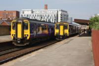On the left a Class 156 DMU heading to Stalybridge while on the right is a Class 150 heading to Kirkby call at Salford Central on 04 June 2016. Significant improvements have been proposed for this station at platform level.<br><br>[John McIntyre 04/06/2016]