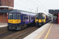 EMUs calling at Wigan North Western on 04 June 2016. The Class 319 is on a Preston to Liverpool service and the Class 350 is heading to Glasgow Central with a service from Manchester Airport.<br><br>[John McIntyre 04/06/2015]