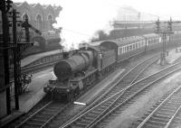 A Great Western 2-6-0 about to take out a train from Southampton Terminus in the late 1930s. The train is thought to be a cross country service via the former Didcot, Newbury & Southampton route. Southampton Terminus closed to passengers in September 1966 although the listed former goods depot in the background still stands (2016). [Ref query 12670] <br><br>[Bruce McCartney Collection //]