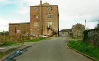 Garlieston Mill was served by the Millisle-Garlieston line which continued beyond the passenger terminus at Garlieston to the mill and pier. The track was to the left in this 2002 view. [See image 2112].<br><br>
<br><br>
The mill has since been demolished however the two storey building to the right and that straight ahead at the pier remain in a new development here.<br><br>[Ewan Crawford //2002]