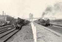 Trains at the Singer Workers Platforms on 12 April 1958, looking west back towards the factory. The locomotives are Ivatt 4MT 2-6-0 43136 and Gresley V3 2-6-2T 67604.  <br><br>[G H Robin collection by courtesy of the Mitchell Library, Glasgow 12/04/1958]