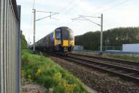 A Trans Pennine service from Edinburgh to Manchester Airport on 13 August 2016 passes the site of the former Coppull station on the WCML between Preston and Wigan.<br><br>[John McIntyre 13/08/2016]