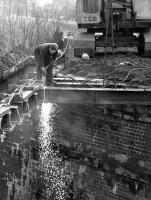 Dismantling the old railway bridge over the A7 at Bridgeheugh on the former Selkirk branch in the 1970s [see image 55058].<br><br>[Dougie Squance (Courtesy Bruce McCartney) //]