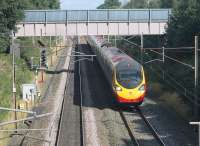 An Edinburgh to Euston Pendolino heads towards Preston near Barton and Broughton on 29th August 2016. The signal on the left controls access to the Down Loop, which can just be seen under the bridge that carries a local water main. This stretch of the WCML had four tracks until around the time of electrification in the early 1970s. [Ref query 3350]  <br><br>[Mark Bartlett 29/08/2016]