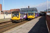 Two pairs of Pacers pass each other at Salford Central on 08 October 3016. The pair on the left are heading to Manchester Victoria just one stop away while the pair on the right are off to Southport.<br><br>[John McIntyre 08/10/2016]