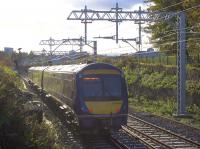 The wiring on the north end of the Cowlairs Incline looks almost complete as the 1306 arrival from Edinburgh descends in the afternoon sunshine on 5th November 2016. However, the supports cease before the Pinkston Road overbridge and there's no knitting yet for some distance up the hill from there.<br><br>[Colin McDonald 05/11/2016]