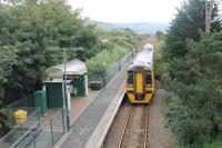 ATW 158832 pulls away from the halt at Talybont with a Pwilhelli to Birmingham International service. This view looks south towards the next minor halt at Llanaber with Barmouth and the Mawddach estuary beyond.  <br><br>[Mark Bartlett 19/09/2016]