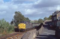 37088 is seen passing the location of the original Newburgh station with an Edinburgh - Inverness train on 19th September 1990.  Just visible above the 3rd carriage is the roof of a bungalow now occupying the site.<br><br>[Graeme Blair 19/09/1990]
