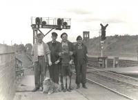 Three railwaymen, a friend, a boy, a dog and a historic old signal box. Posed portrait (names unknown) at the north end of Dumfries station in the summer of 1961. <br><br>[G H Robin collection by courtesy of the Mitchell Library, Glasgow 15/07/1961]