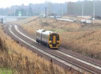 ScotRail 158731 approaching Shawfair from the south on a dismal 15 December 2016 with the 1126 Tweedbank – Edinburgh Waverley. The train has just passed below the Edinburgh City Bypass and is on the double track section between Kings Gate and Newcraighall South. The parallel road traffic is on the rerouted A6106, with Sheriffhall Roundabout in the right background.<br><br>[John Furnevel 15/12/2016]