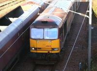 EWS 60029 <I>Clitheroe Castle</I> entering Millerhill Yard from the north in November 2004 with empties returning from STVA Bathgate [see image 18357]. The train is passing a class 66 heading in the opposite direction with coal empties. The line visible top left is the reversing siding used by trains terminating at nearby Newcraighall station.  <br><br>[John Furnevel 23/11/2004]