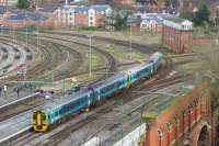 A pair of Arriva Trains Wales Class 158s departs Shrewsbury on the afternoon of 22 March 2017 heading towards Telford. The view is from the castle ramparts looking at Severn Bridge Jct and the large mechanical signalbox of the same name.<br><br>[John McIntyre 22/03/2017]