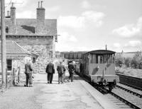 Various 'friends of the last freight' on the eastbound platform at Earlston on a fine and sunny 16 July 1965. At the other end of the train is D3888, preparing to head for Greenlaw.<br><br>[Bruce McCartney 16/07/1965]