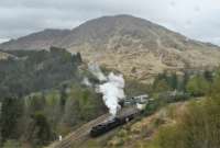 In light rain, a Jacobite service, returning from Mallaig, leaves Glenfinnan. The view is from <i>The Viaduct Trail</i>, a relatively easy path (think West Highland Way) from the station to above the west end of Glenfinnan Viaduct. <br><br>[Ewan Crawford 27/04/2017]