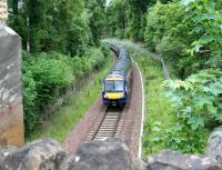 Approaching the end of the single line section from Fushiebridge at Kings Gate on 28 May 2017 is the 6-car 0845 Tweedbank - Edinburgh.<br><br>[John Furnevel 28/05/2017]