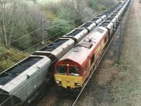 Loaded and empty coal trains hauled by EWS class 66 locomotives pass at the north end of Millerhill Yard in September 2000 on the busy coal route between the Edinburgh sub and the ECML. The loaded train is hauled by 66049, with 66164 approaching at the head of the empties.<br><br>[John Furnevel 11/09/2000]