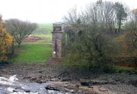 Remains of Tongland Viaduct on the east side of the River Dee in November 2005. Rubble from the demolished main sections of the former bridge can be seen in the field alongside.<br><br>[John Furnevel 18/11/2005]