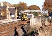 An Aberdeen - Inverness train calls at Nairn on a bright Autumn day in October 2005. The line in the foreground served the former goods yard [see image 40189].<br><br>[John Furnevel 31/10/2005]