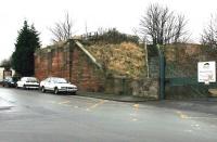 Looking south in December 2004 at the remaining abutment of the bridge across Seafield Street which carried the E&D line on its way up from Meadows Junction and yard (off picture to the left) towards Seafield Junction. The stairs provide access to the trackbed, which is now part of a walkway. [See image 6697] <br><br>[John Furnevel 10/12/2004]