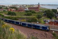 380111 leaving Ardrossan Town, passing the platform extension at the north end. The South Beach (the actual beach, not the station) is seen in the background.<br><br>[Ewan Crawford 10/08/2017]