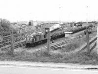 View south over Millerhill yard in the spring of 1980, with EE Type 3 37083 ready to leave with a freight.<br><br>[John Furnevel 22/04/1980]