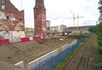 Progress at Shrubhill on 19 September 2017, looking south east towards Leith Walk. Further demolition has taken place and major new construction is apparent in the background beyond the cranes. Parts of the old tram depot scheduled for preservation stand in the left foreground, including the unique octagonal works chimney. The rusting Powderhall branch runs off to the right.<br><br>[Andy Furnevel 19/09/2017]