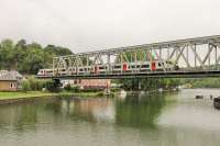 SNCB EMU 08520 leaves Anseremme station and runs onto the River Meuse bridge with a stopping service from Libramont to Namur on 8th September 2017. <br><br>[Mark Bartlett 08/09/2017]