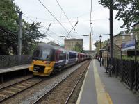 333004 leaves Saltaire station heading for Shipley and Bradford Forster Square on 23rd September 2017. In the background is the famous Salts Mill, centrepiece of the village. Is there another UK station that has <I>World Heritage Site</I> on it's platform signs?<br><br>[Mark Bartlett 23/09/2017]
